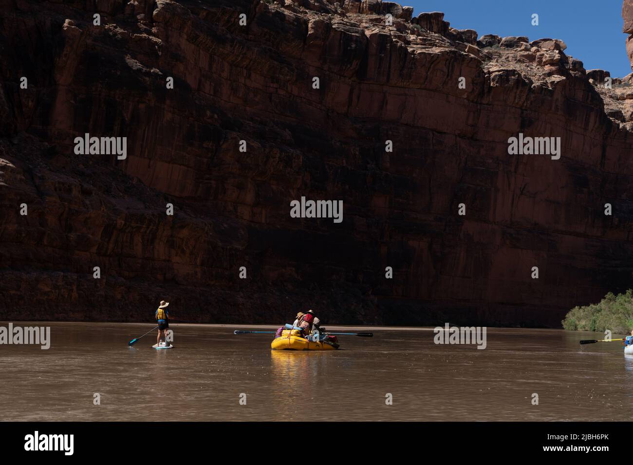 River explorers and tourists navigate their boats, rafts, paddle boards 