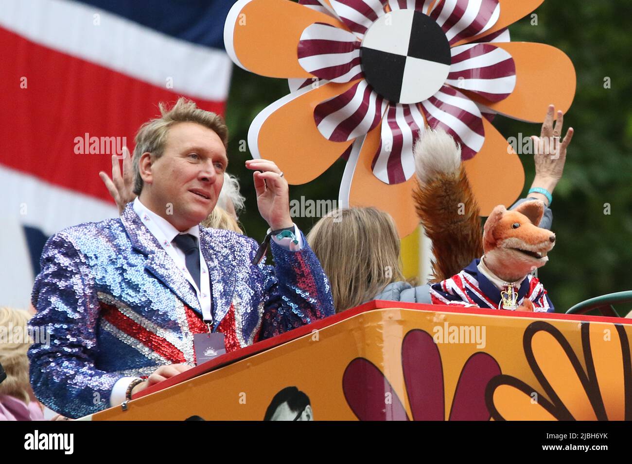 (L to R) Michael Winsor and Basil Brush on an open top bus at the 2022