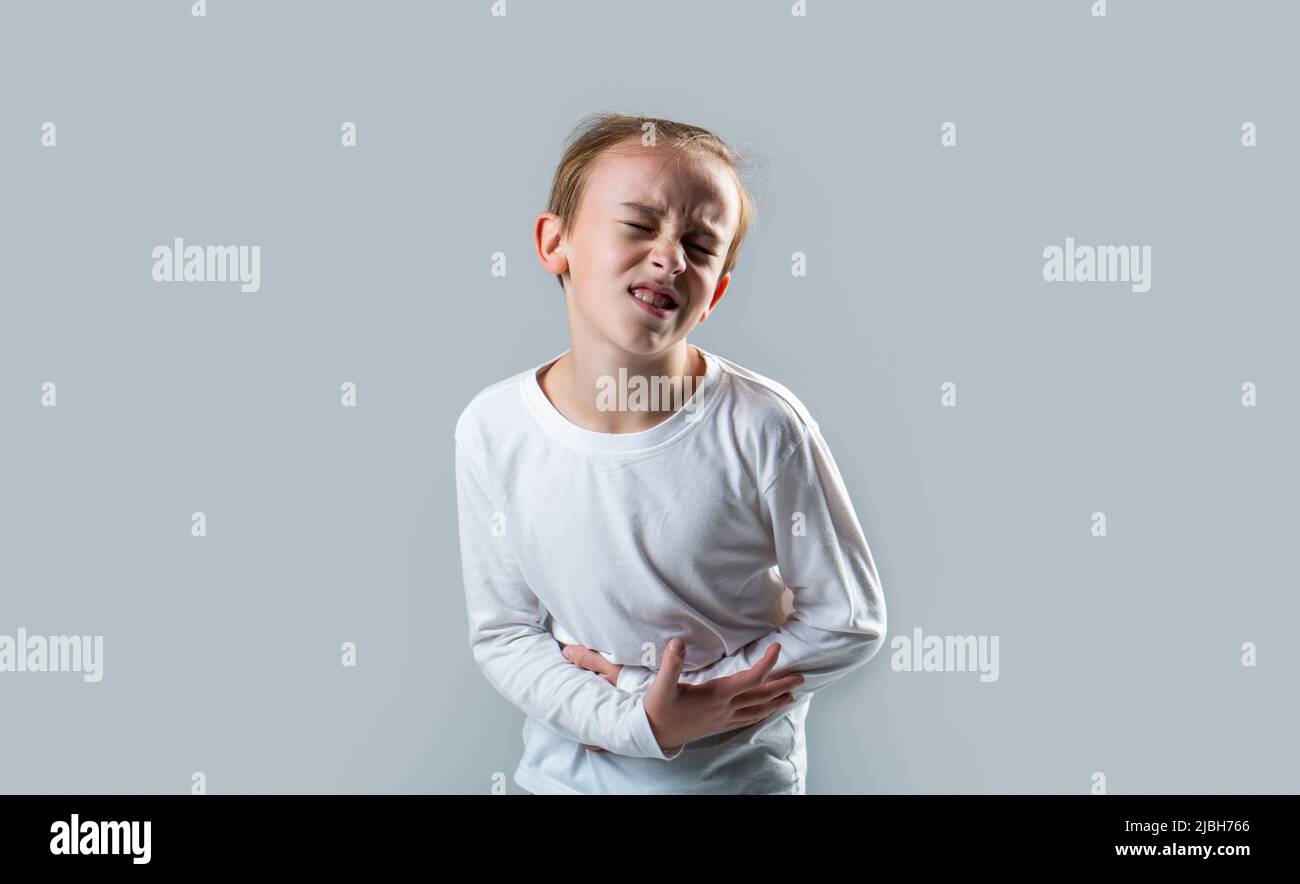Stomach pain. Teen boy with stomachache. Child having terrible pain in