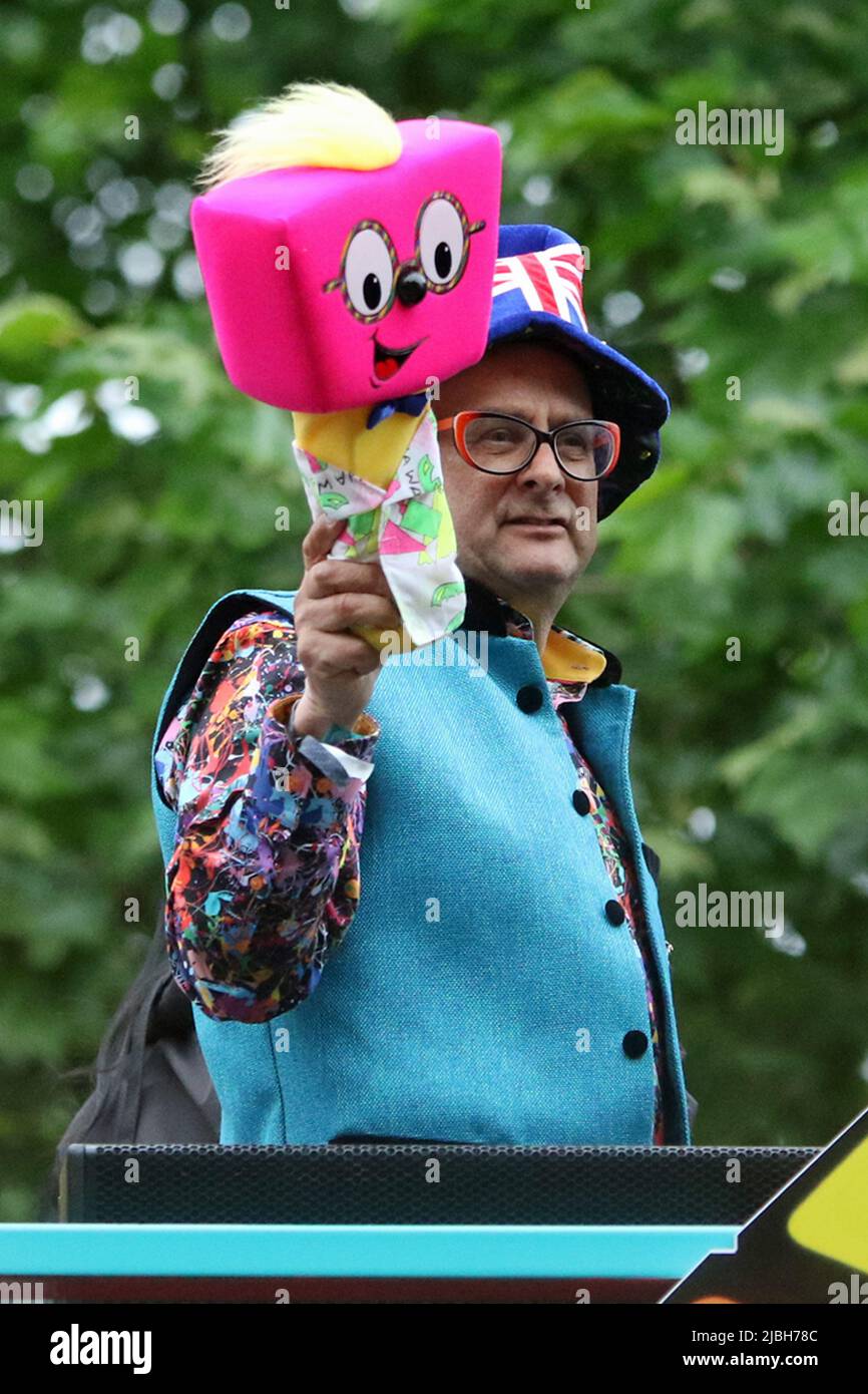 Timmy Mallett is an English TV presenter, broadcaster, and artist. He is known for his striking visual style, colourful glasses, loud shirts, and giant pink foam mallet, known as 'Mallett's Mallet'. On an open top bus at the 2022 Platinum Jubilee Pageant in the Mall, London Stock Photo