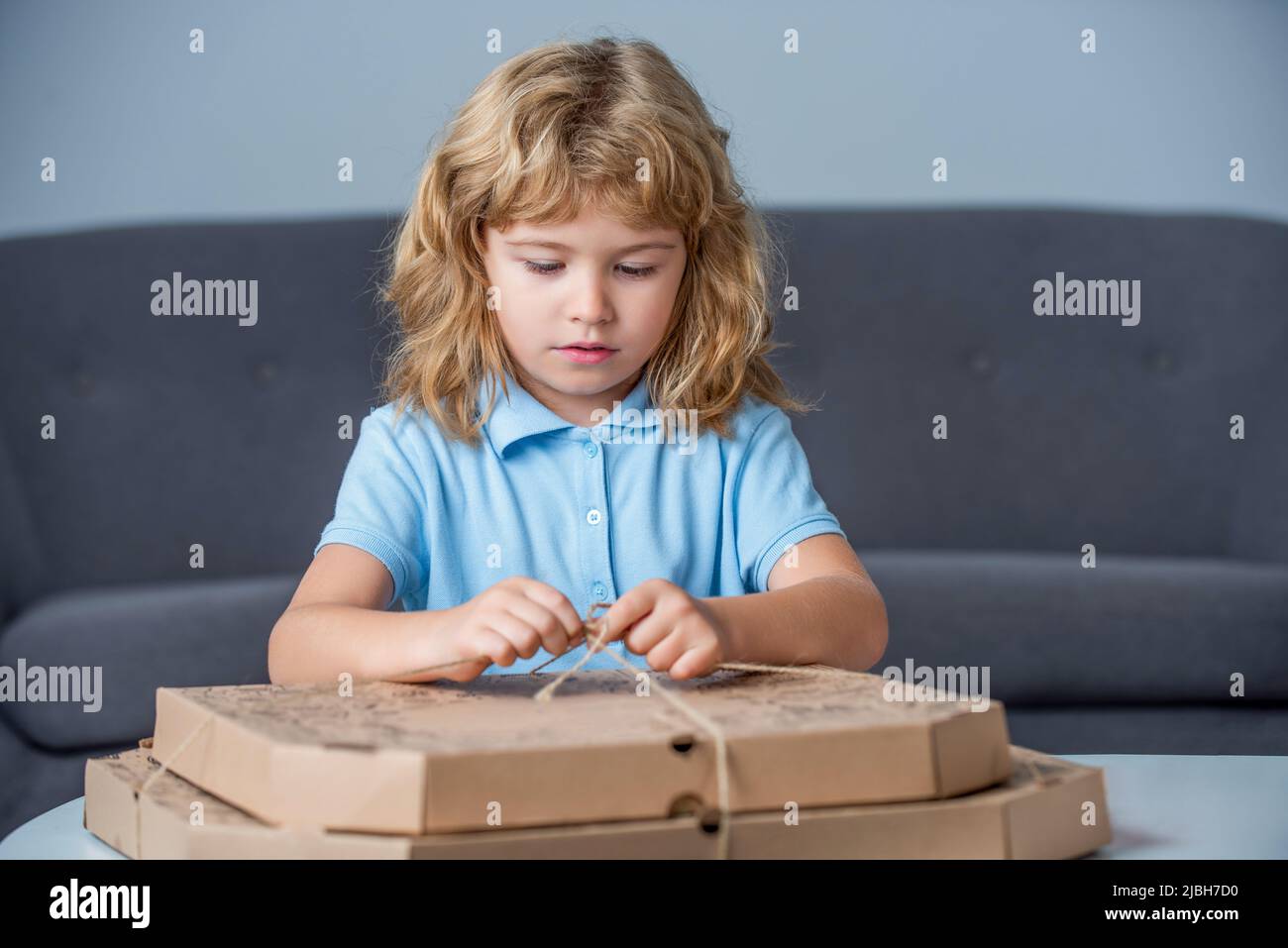 Little boy holding pizza boxes. Boy ready to eat a pizza. Little child ...