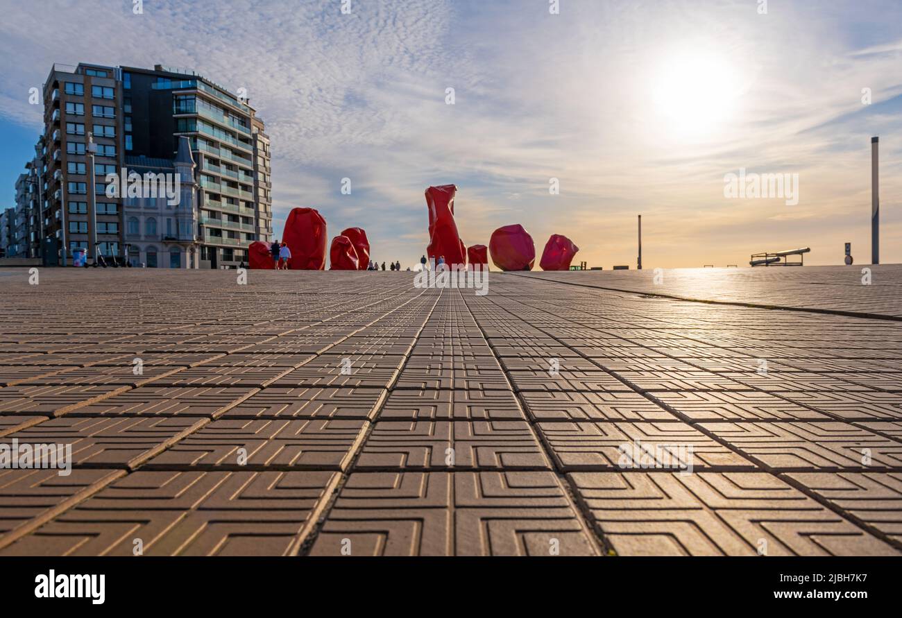 Low angle perspective of the waterfront promenade in Oostende (Ostend) at sunset by the North Sea, Belgium. Stock Photo