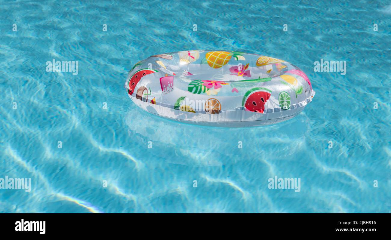 Hello summer concept with inflatable ring in the pool. Stock Photo