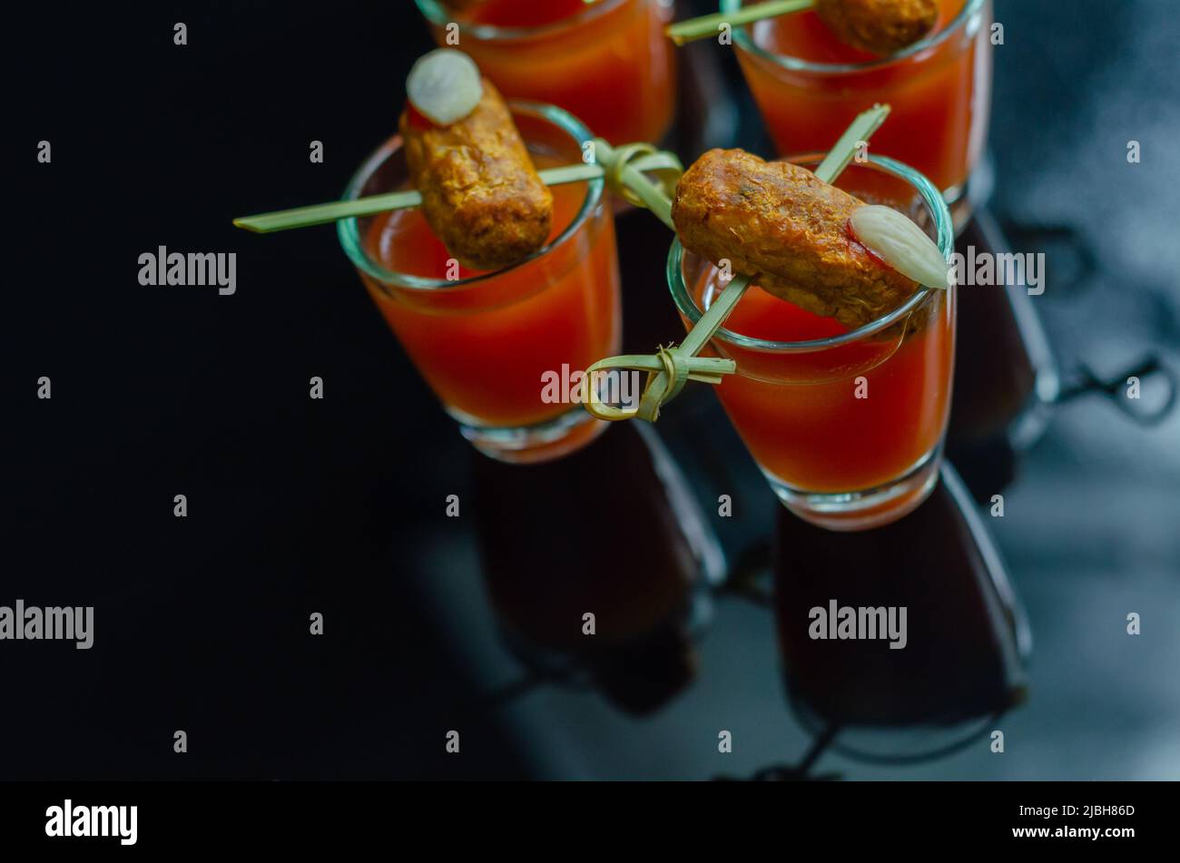 https://c8.alamy.com/comp/2JBH86D/bloody-mary-cocktails-in-the-shots-drink-served-with-halloween-bloody-fingers-pork-cocktail-sausages-decorated-with-flaked-almonds-funny-food-2JBH86D.jpg