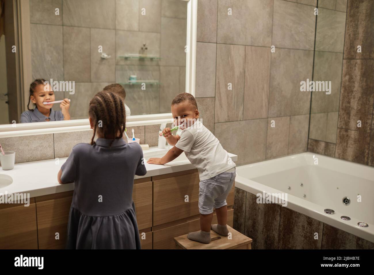 Portrait of two African American kids in bathroom focus on little