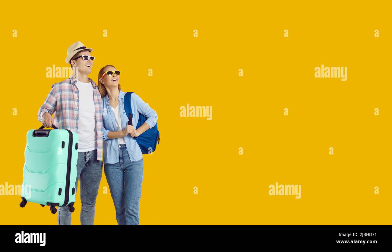 Happy young couple of travelers enjoy trip abroad on weekend and look at copy space with delight. Stock Photo