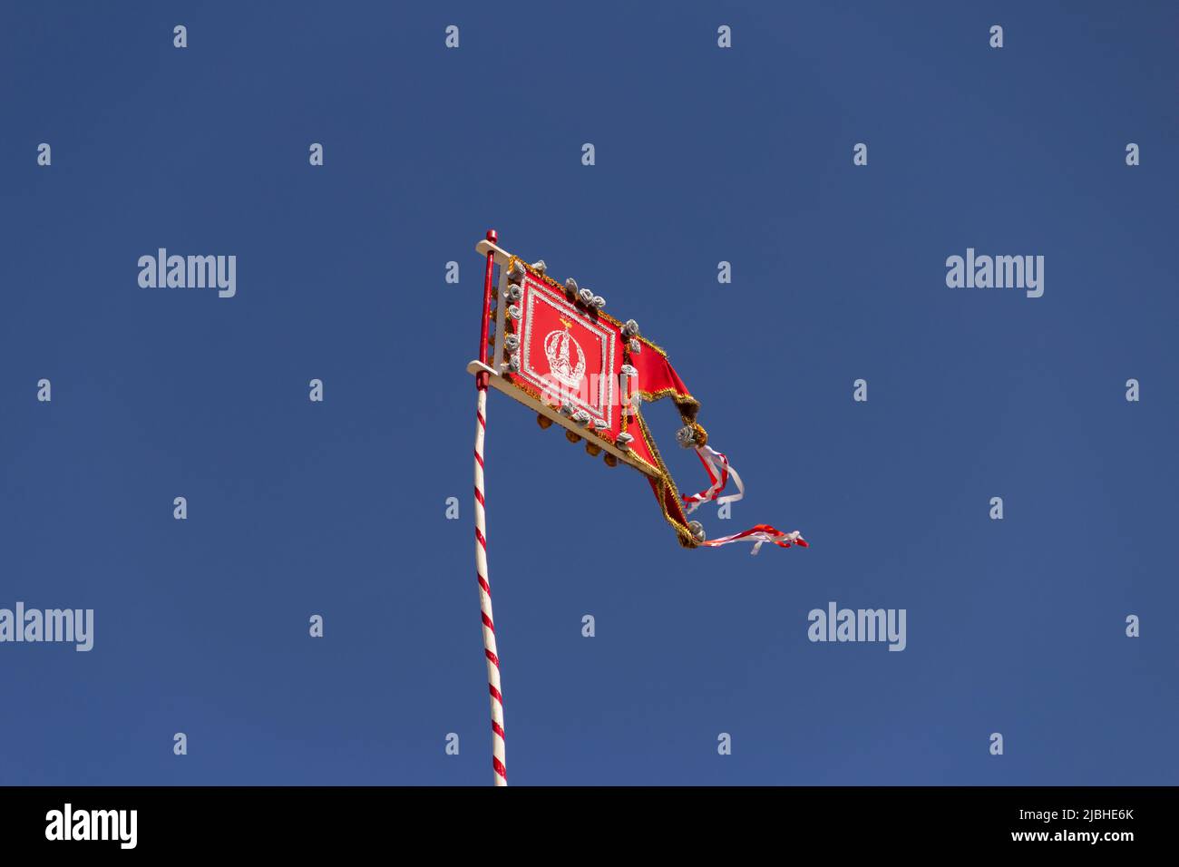 Pirenópolis, Goiás, Brazil – June 05, 2022: A flag with the crown of the Divine Eternal Father embroidered on a pole, with flags around it. Stock Photo