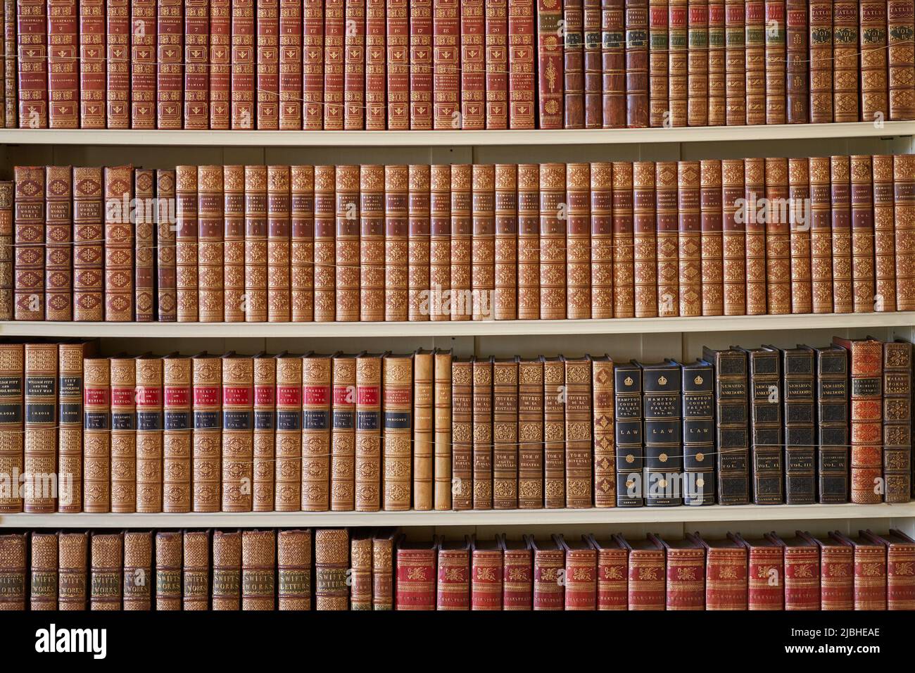 Bookshelves filled with old leather bound books Stock Photo