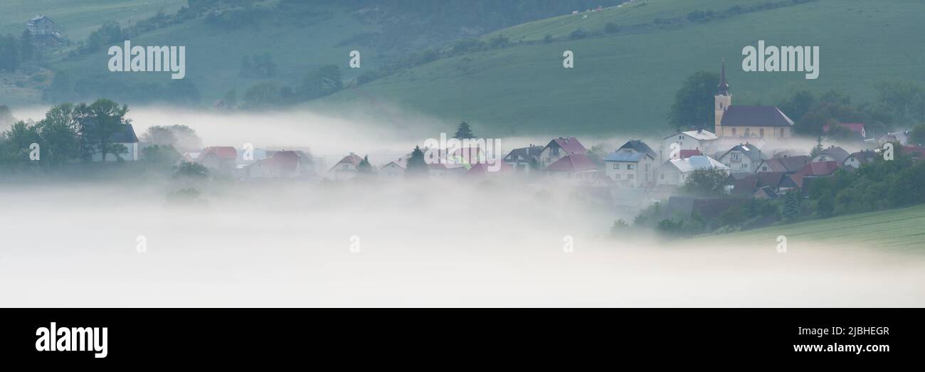 Foggy Turcianske Jaseno village in Turiec region, Slovakia. Stock Photo