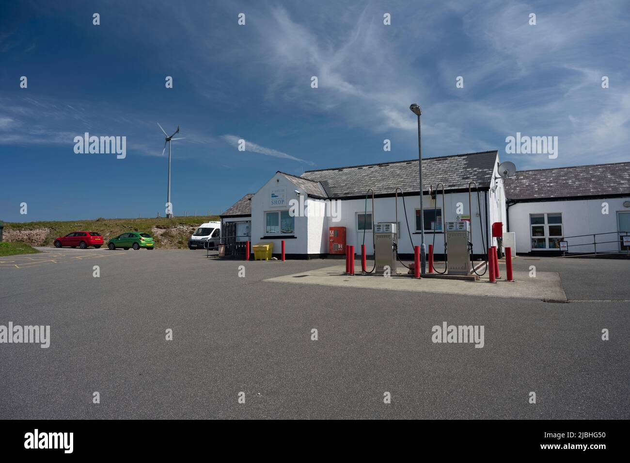 Exterior of Uig community shop and petrol station. No people, sunny day with blue sky and clouds. Isle of Lewis, Outer Hebrides, Scotland, UK. Stock Photo