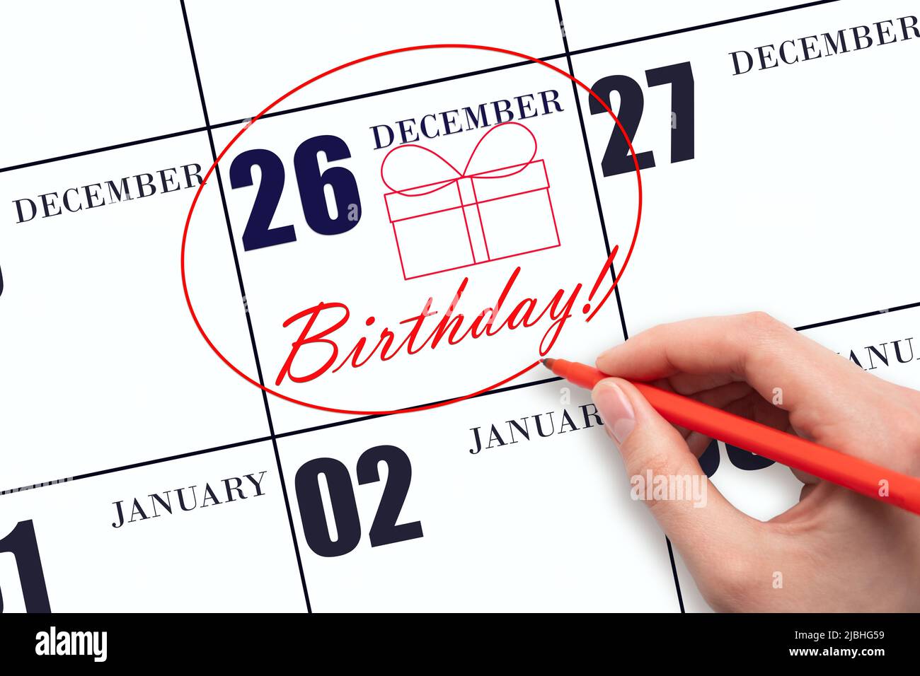 26th day of December. The hand circles the date on the calendar 26 December, draws a gift box and writes the text Birthday. Holiday. Winter month, day Stock Photo