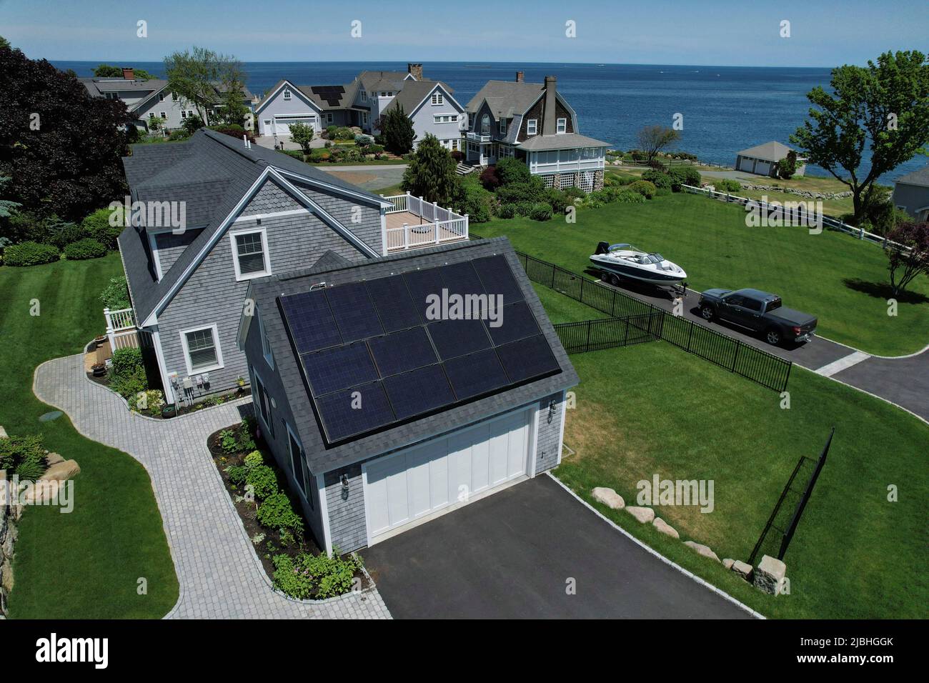 Solar panels create electricity on the roof of a house in Rockport, Massachusetts, U.S., June 6, 2022. Picture taken with a drone.    REUTERS/Brian Snyder Stock Photo