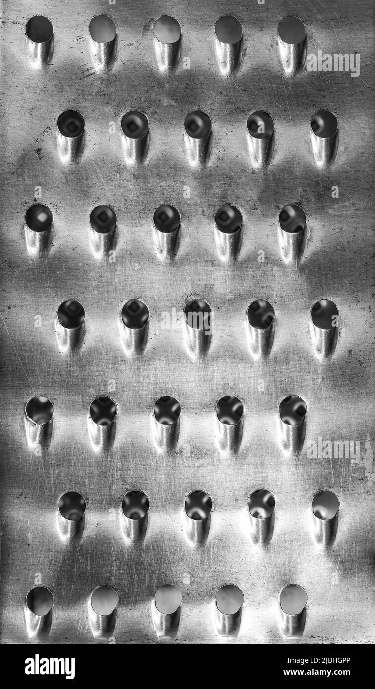 Closeup on old used kitchen grater abstract background Stock Photo