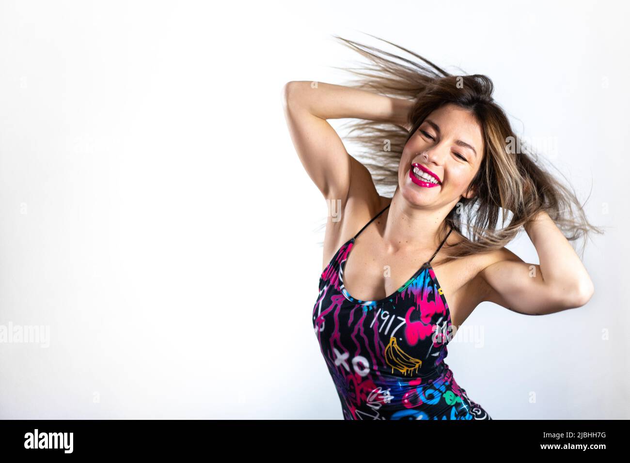 Smiling woman instructor performing a dance movement Stock Photo