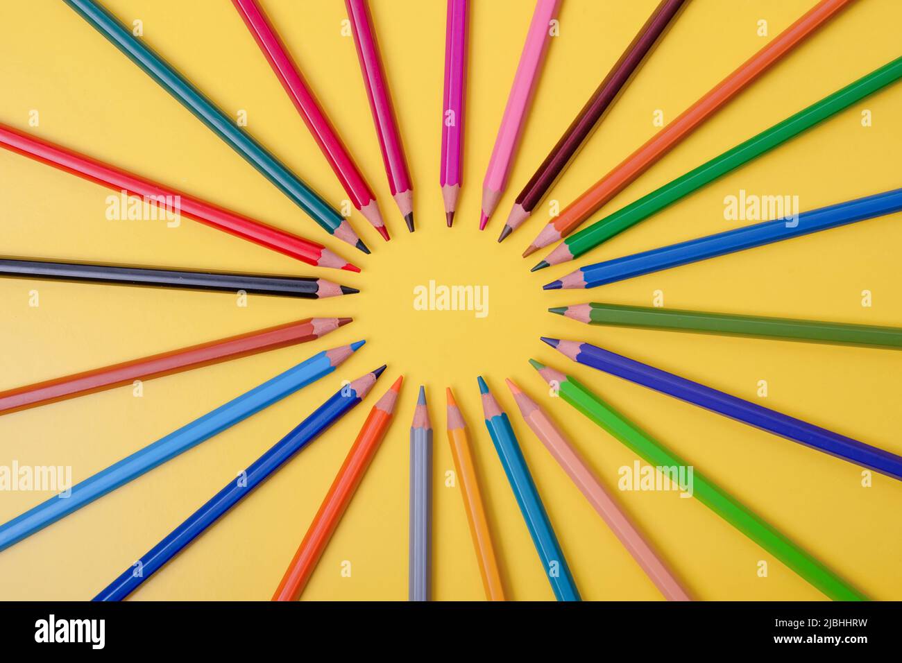 a few colored pencils on a yellow-blue background Develop creativity Get creative Stock Photo