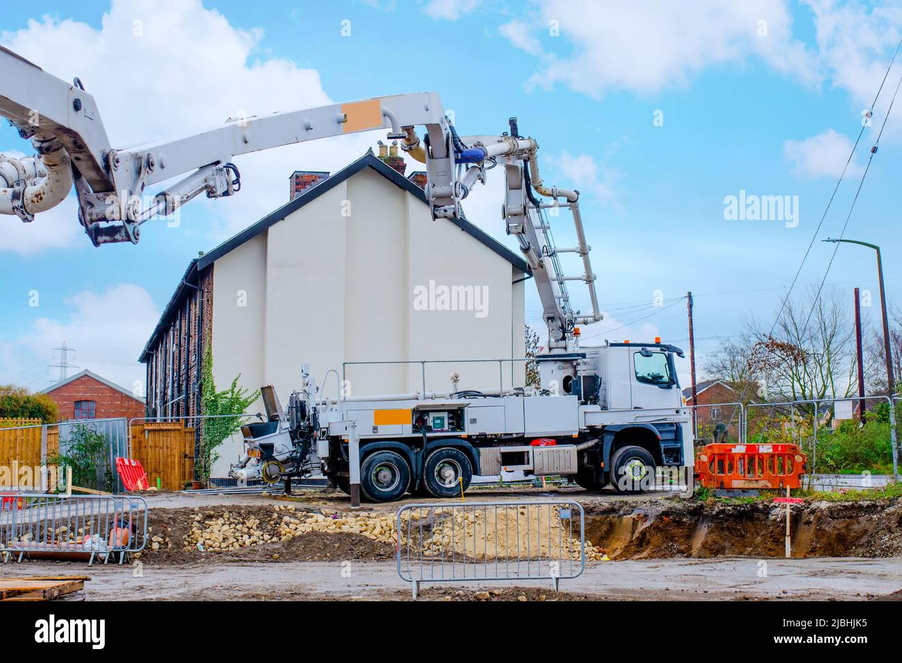 Concrete pump set on construction site awaiting concrete delivery Stock