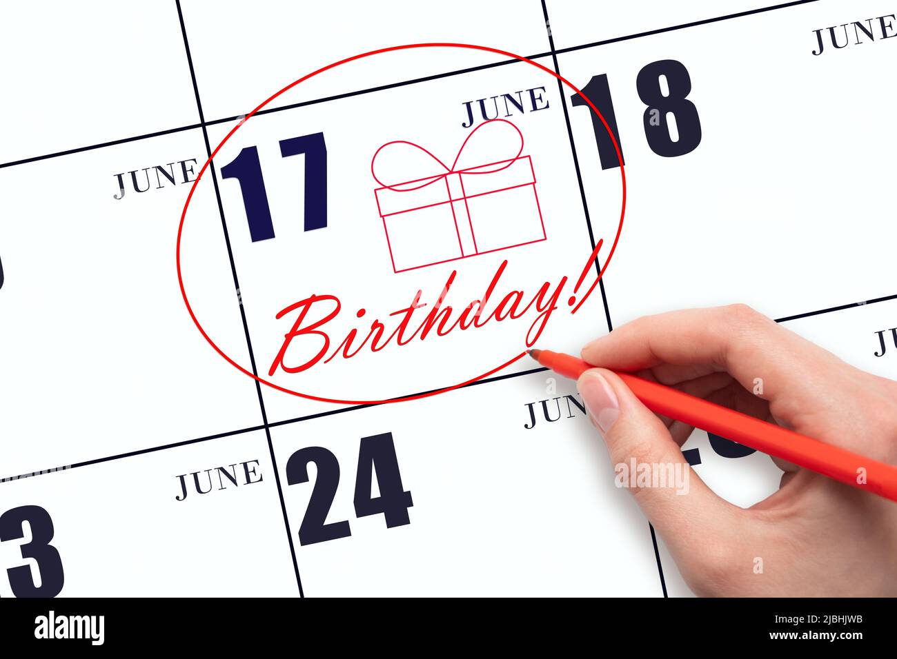 17th day of June. The hand circles the date on the calendar 17 June, draws a gift box and writes the text Birthday. Holiday. Summer month, day of the Stock Photo - Alamy