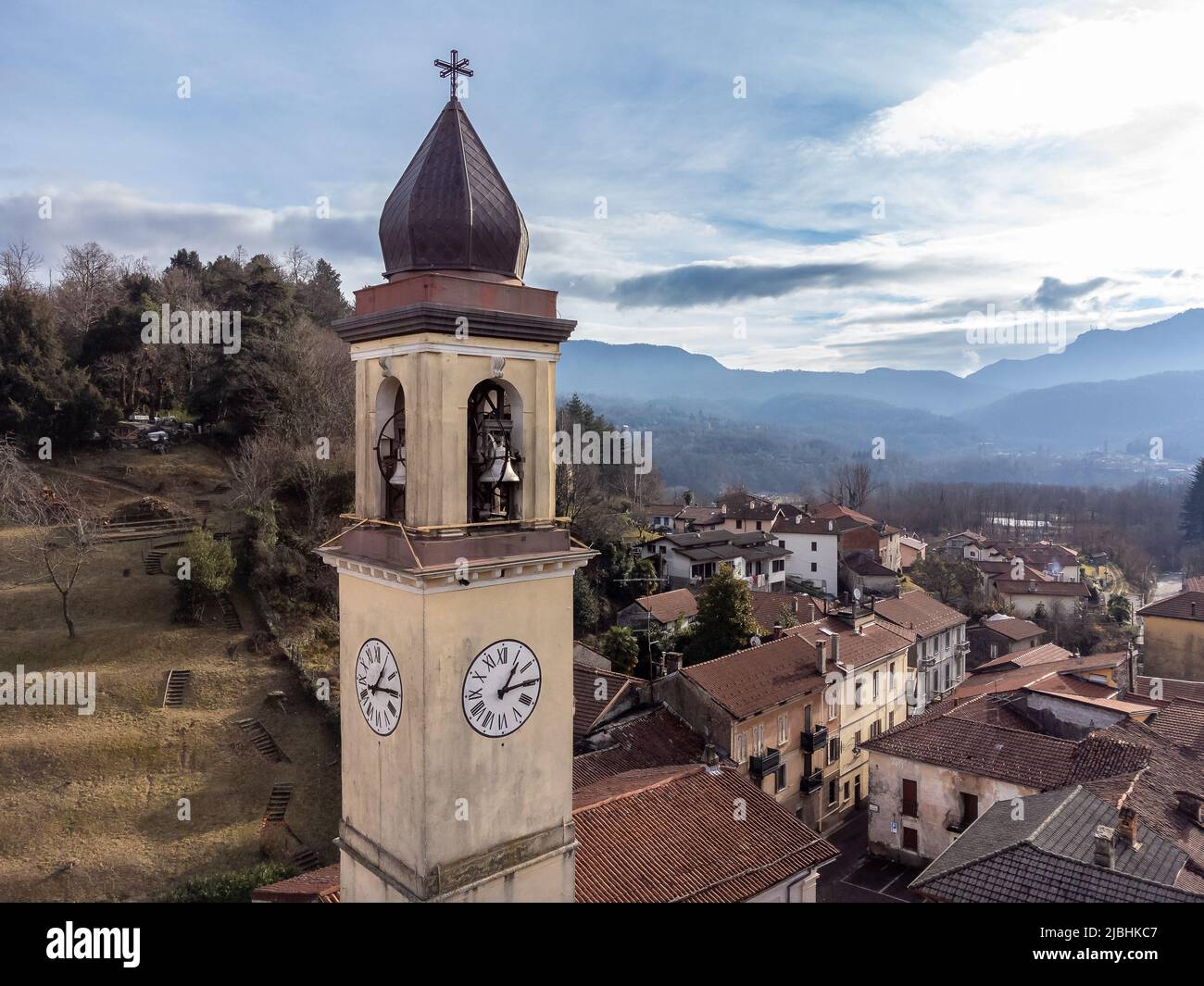 Aerial view of the bell tower of the Ippolito and Cassiano church in Cassano Valcuvia, province of Varese, Lombardy, Italy Stock Photo