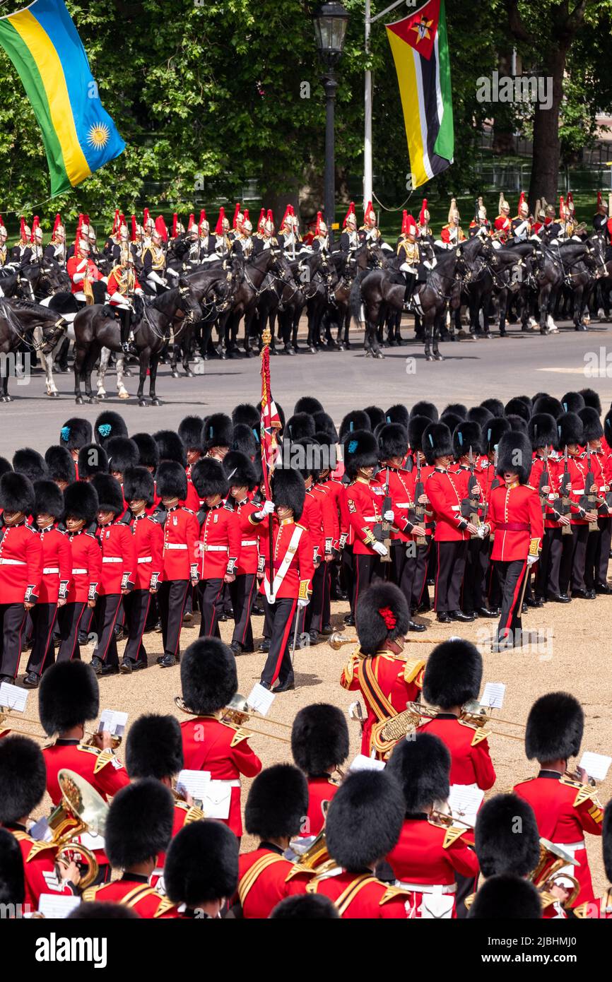 Uniformed guardsmen and women in black and red marching at Horseguards