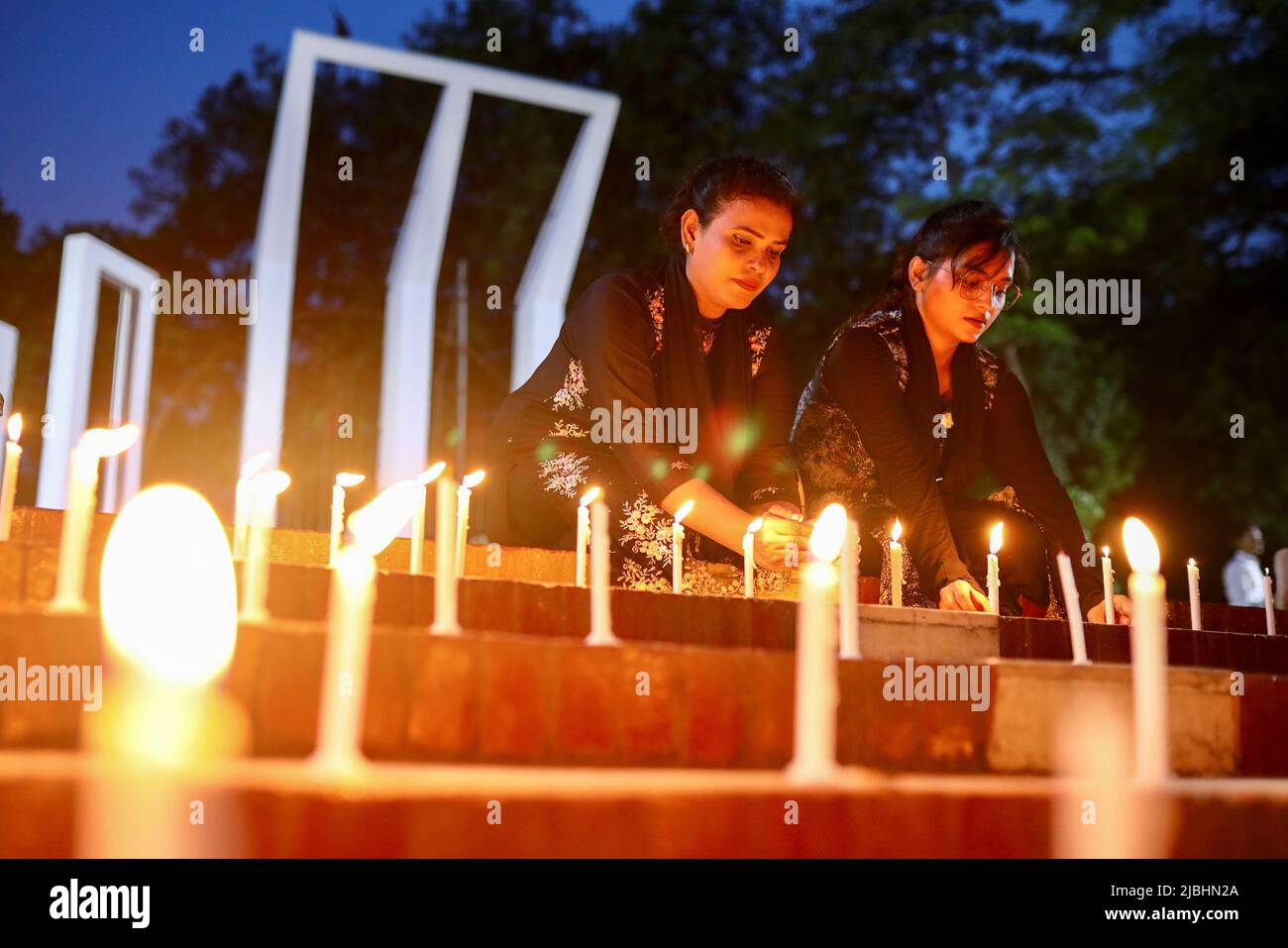 Members of Sommilito Sangskritik Jote organisation participate in a candlelight vigil in remembrance of the victims of the fire that broke out in an inland container depot in Sitakunda, in Dhaka, Bangladesh, June 6, 2022. REUTERS/Mohammad Ponir Hossain Stock Photo