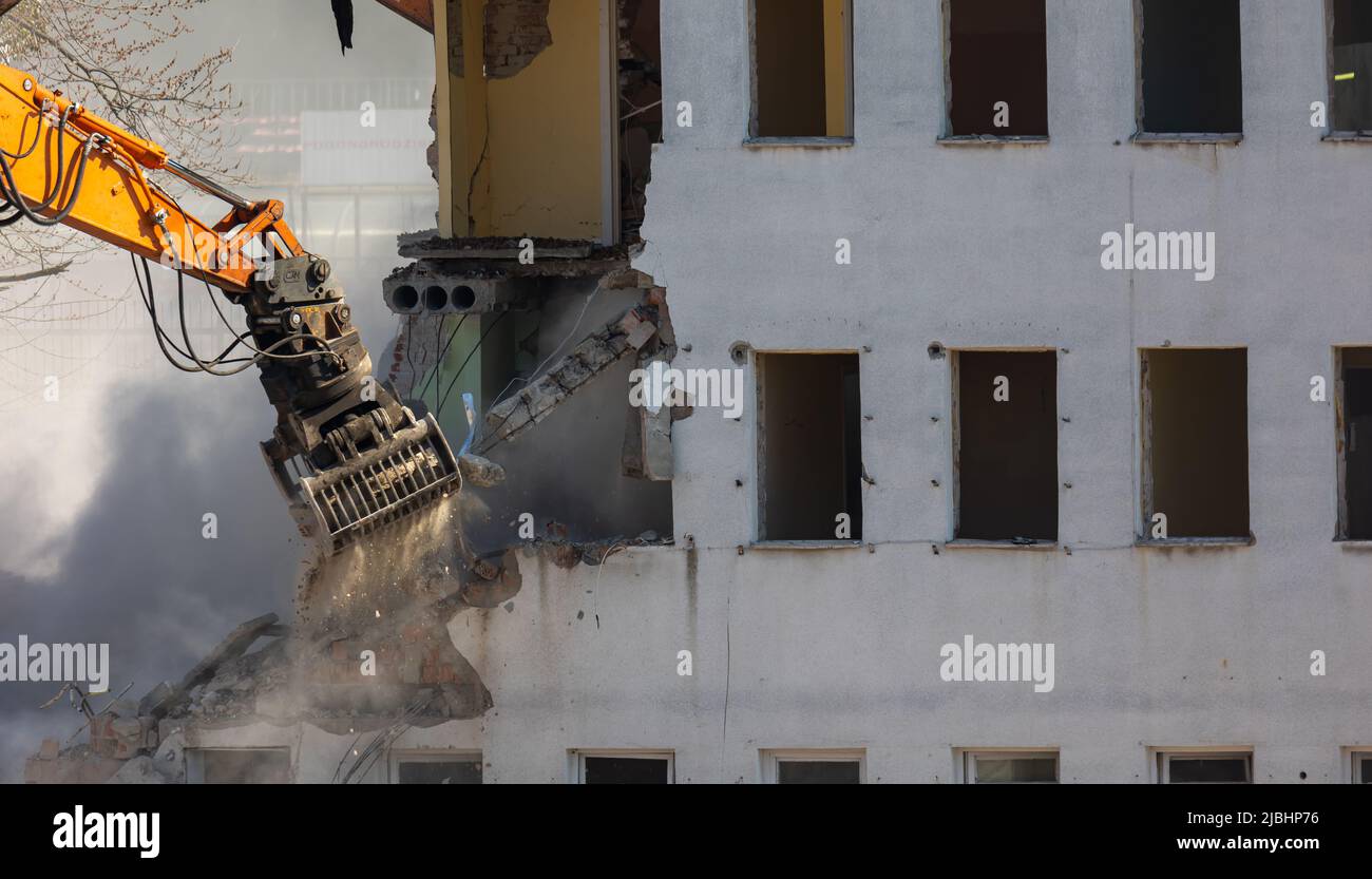 Close up of a bucket of an excavator demolishing an old building ...