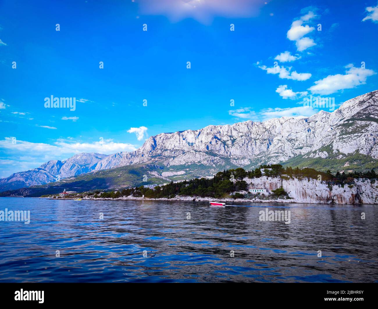 View of the Makarska mountains from a yacht at sea. Biokovo is a limestone mountain range in Croatia in the Split-Dalmatia County. Stock Photo