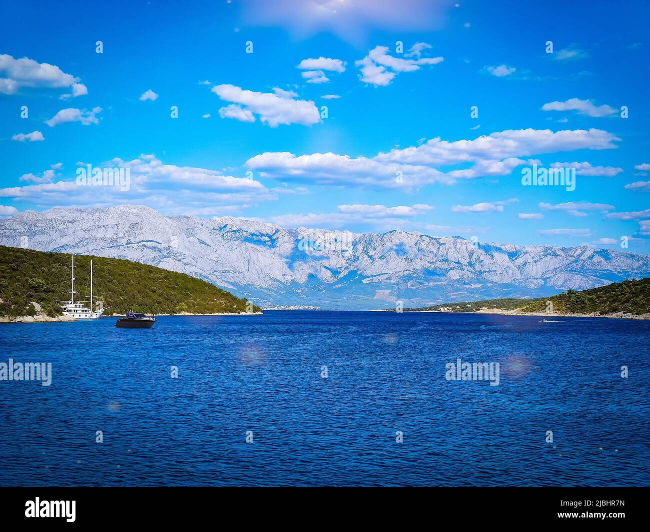 View of the Makarska mountains from a yacht at sea. Biokovo is a limestone mountain range in Croatia in the Split-Dalmatia County. Stock Photo