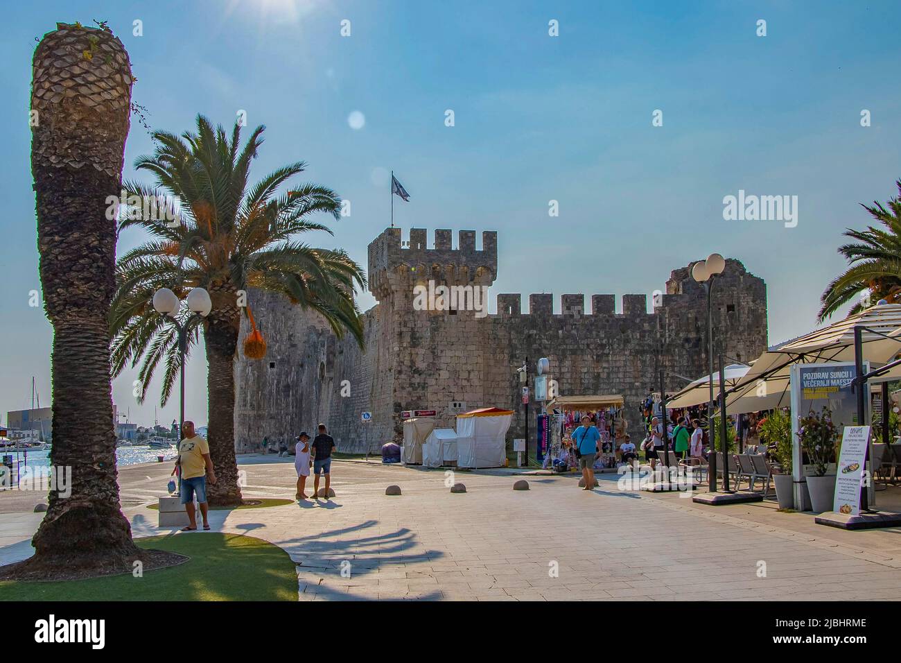 Trogir, Croatia- September 4, 2021: PSunny promenade along the pier of old Venetian town, Trogir, Croatia. Stock Photo