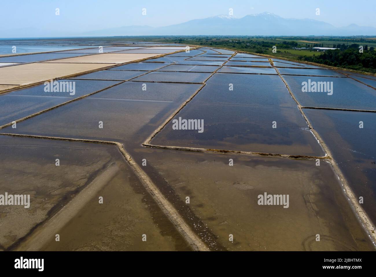 Aerial view of salt evaporation ponds and salt mounds these ponds are filled from ocean and salt crystals are harvested. Kitros Pieria, Greece Stock Photo