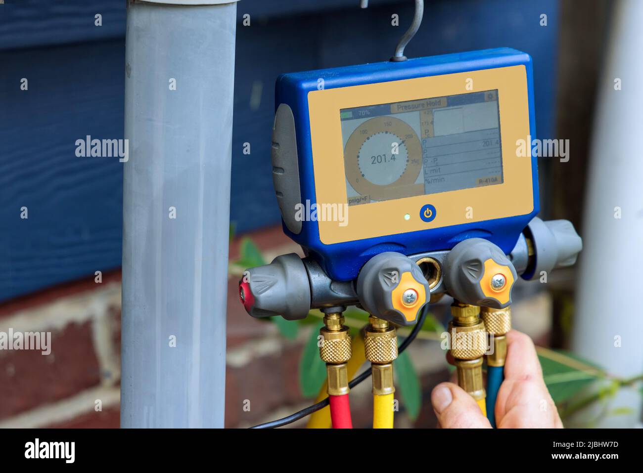 Technician is checking air conditioner with multimeter Stock Photo