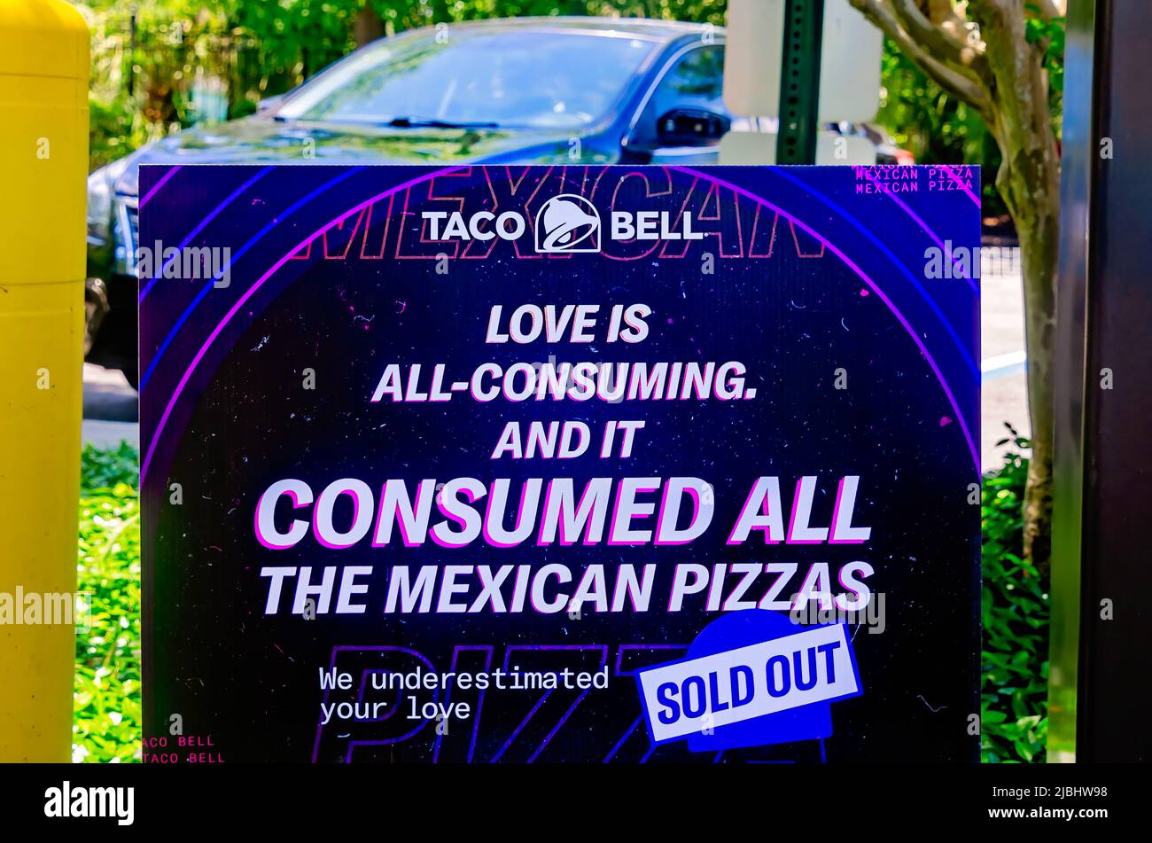 A Taco Bell drive-thru sign confirms Mexican pizzas are sold out at the Government Street location, June 4, 2022, in Mobile, Alabama. Stock Photo