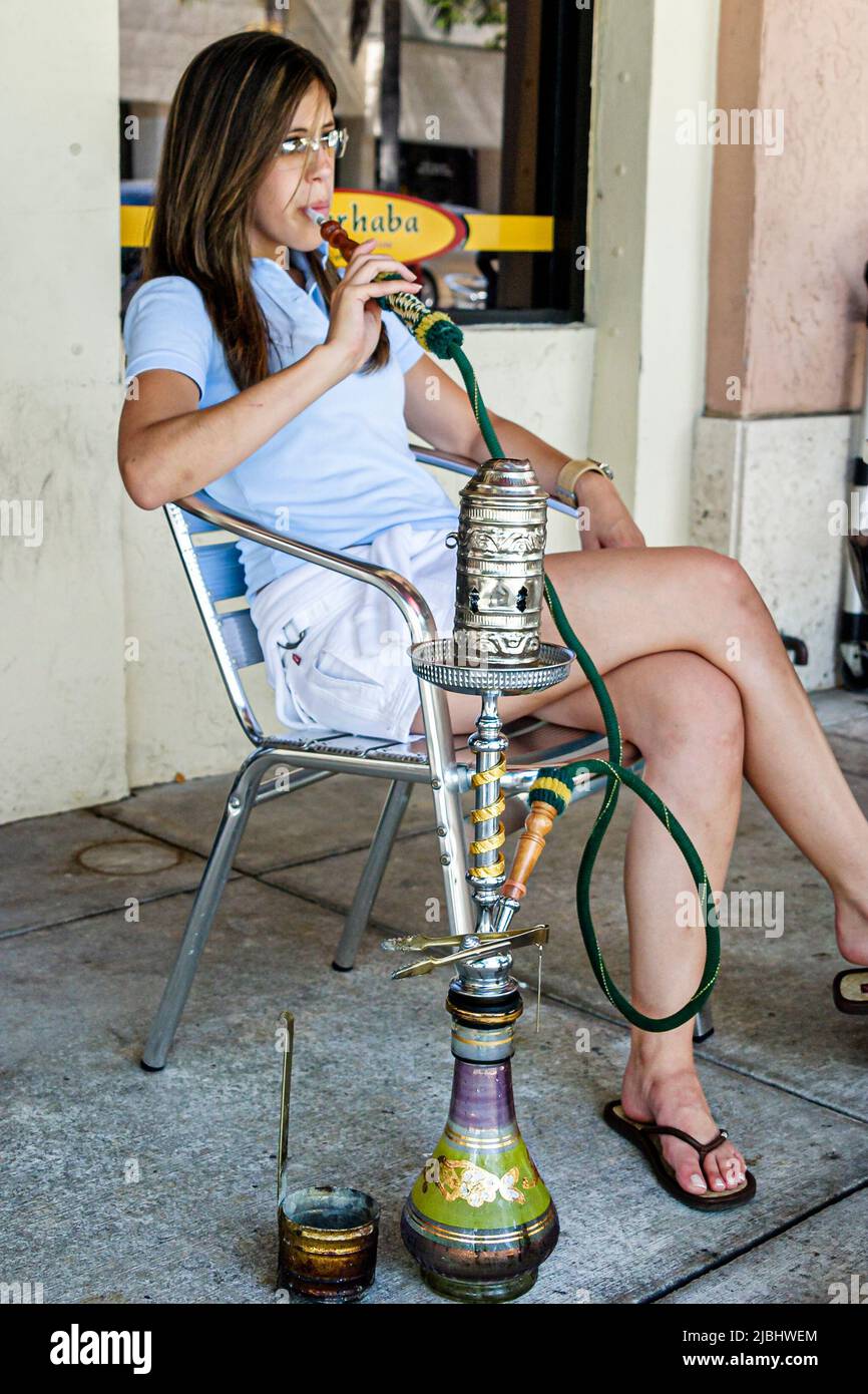 Miami Florida,South Miami,Marhaba Lebanese restaurant café woman female smoking hooka Stock Photo