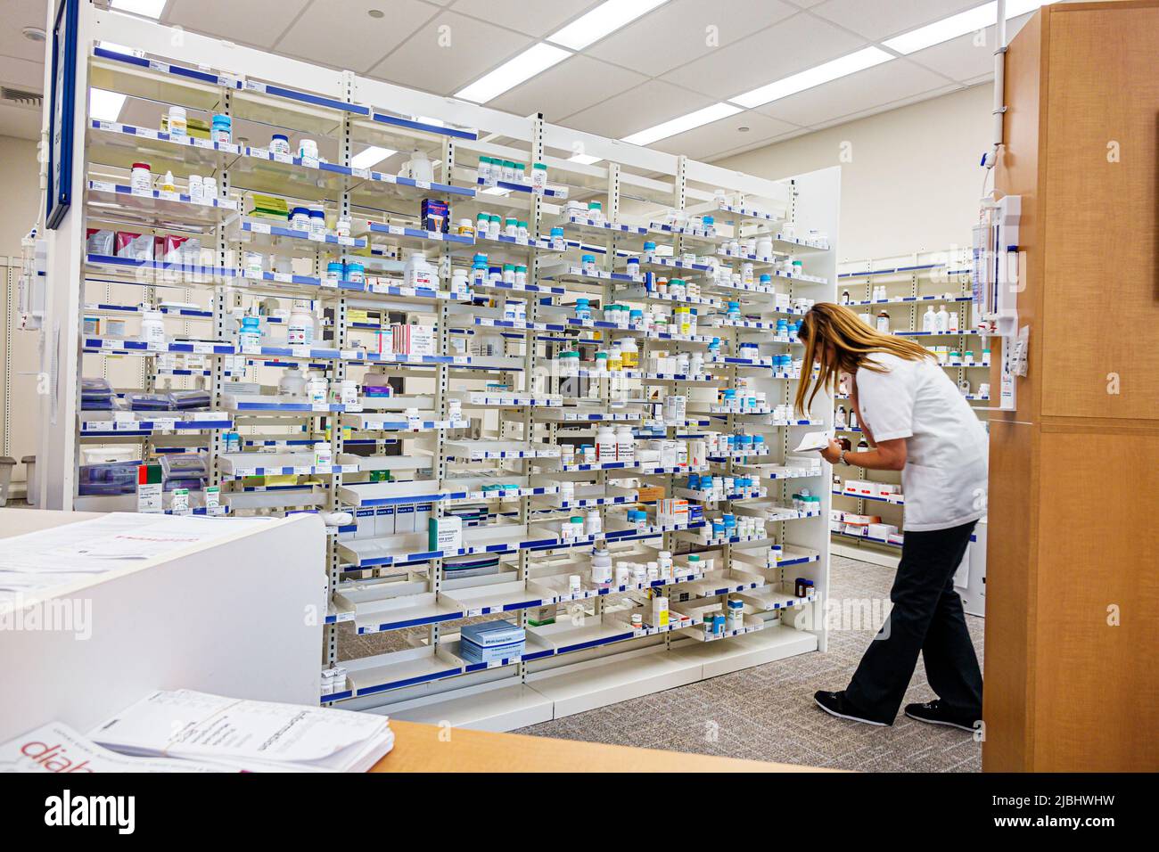 Miami Beach Florida,Walgreens pharmacy,drugstore pharmacist woman female filling prescription,employee worker working staff medicine drugs Stock Photo