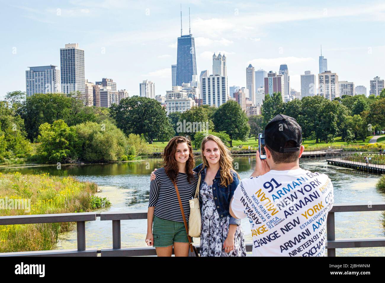 Chicago Illinois,North Side,Lincoln Park,Lincoln Park Zoo,Nature Boardwalk,skyline downtown girls teen teens teenagers taking photo iPhone posing Stock Photo