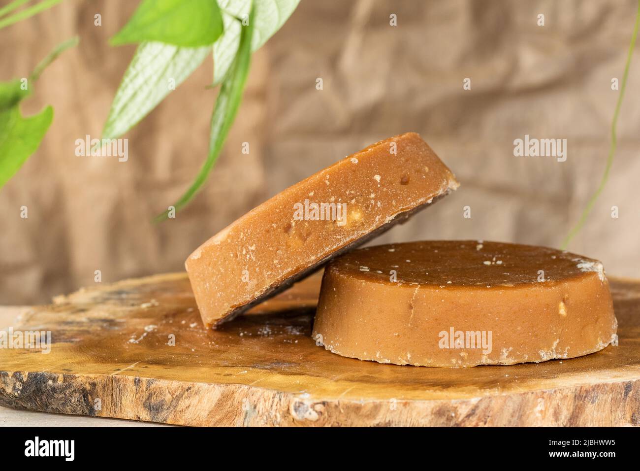 Colombian panela or sugar cane candy, ready to be consumed in various typical dishes. piloncillo ready for sale and marketing, placed on a wooden boar Stock Photo