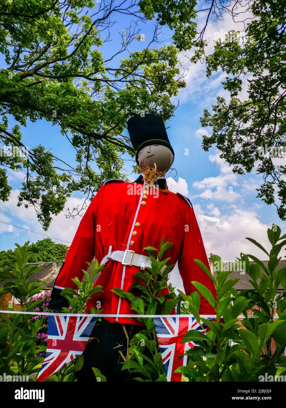 Soldier scarecrow in a village garden during the platinum jubilee. Stock Photo