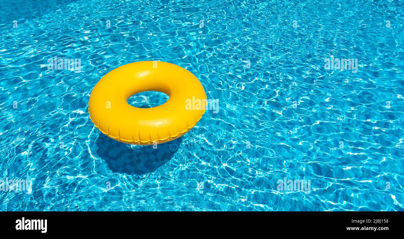 Yellow ring floating in blue swimming pool. Inflatable ring, rest concept Stock Photo