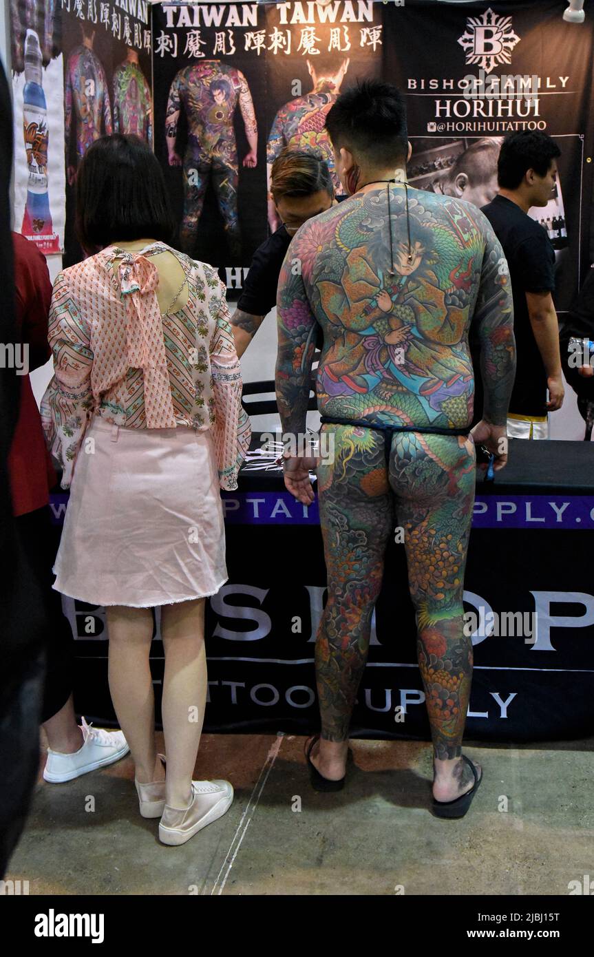 LANGFANG, CHINA MAY 05 2019 A Man with fully tattooed backs show off