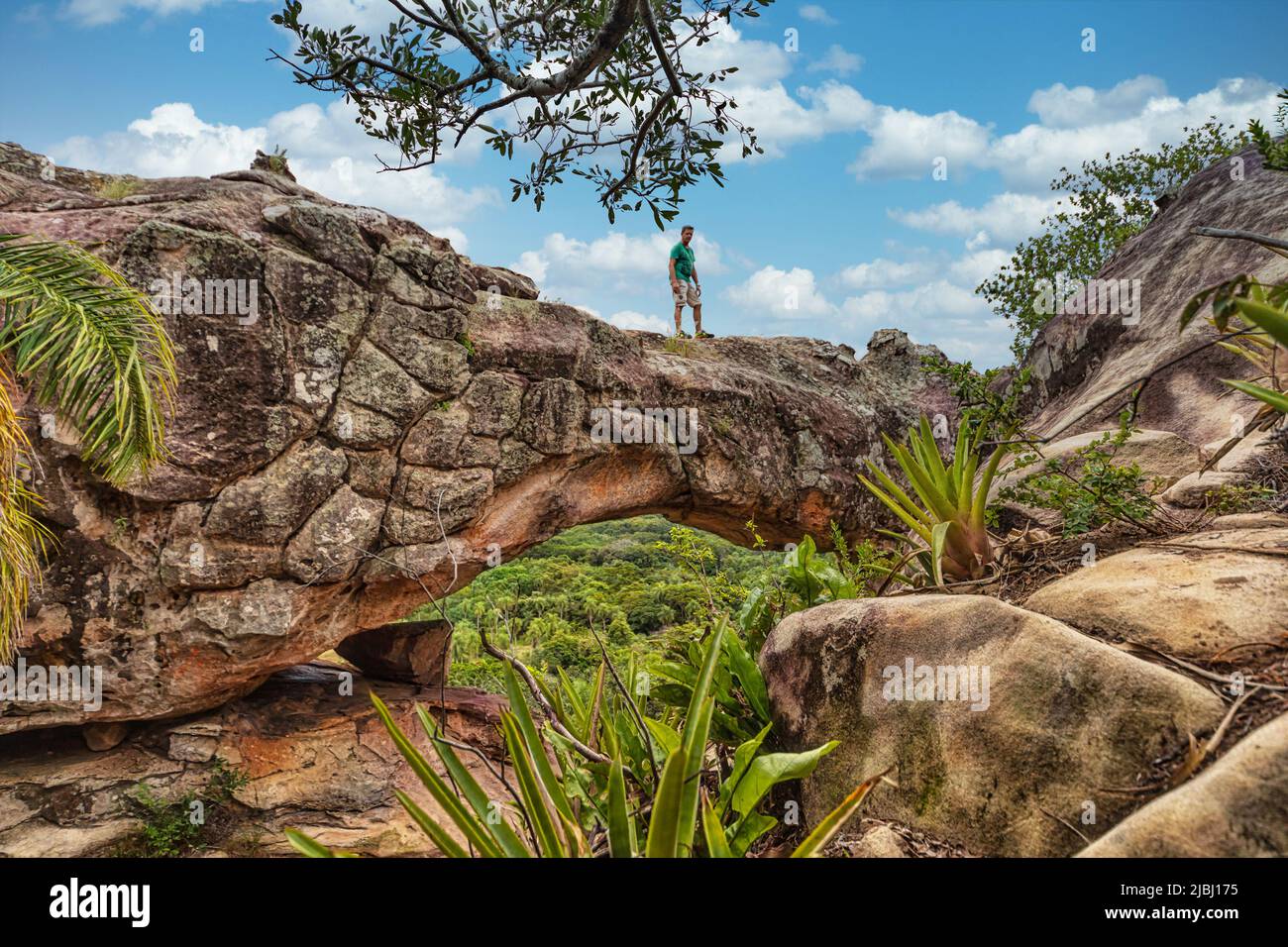 A man on the rock arch on Cerro Arco in Tobati in Paraguay. Stock Photo