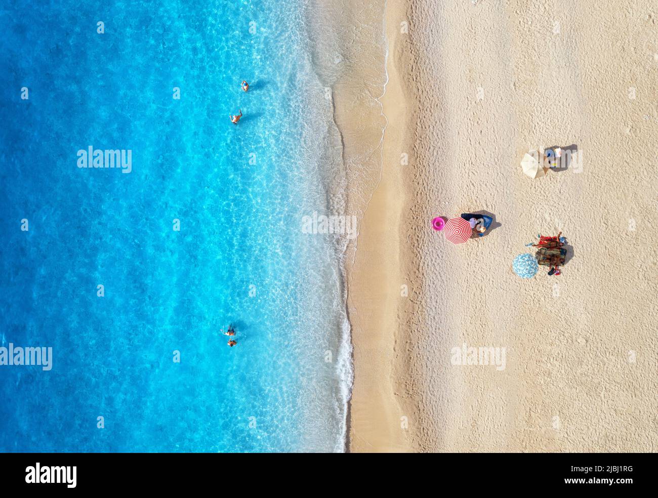 Aerial view of adriatic sea, waves, sandy beach and umbrellas Stock Photo