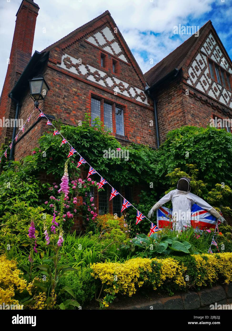 Beekeeper scarecrow in a garden in the village of Great Budworth, Cheshire during the platinum jubilee. Stock Photo