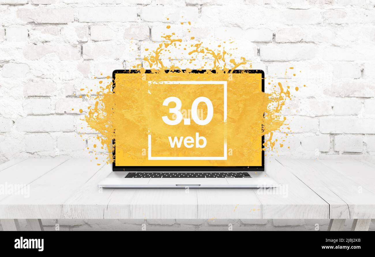 Laptop on the table from which the yellow liquid comes out as a Web 3.0 concept Stock Photo