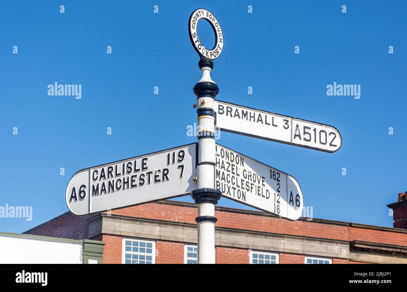 Classic distance sign, Station Road, Stockport, Greater Manchester, England, United Kingdom Stock Photo