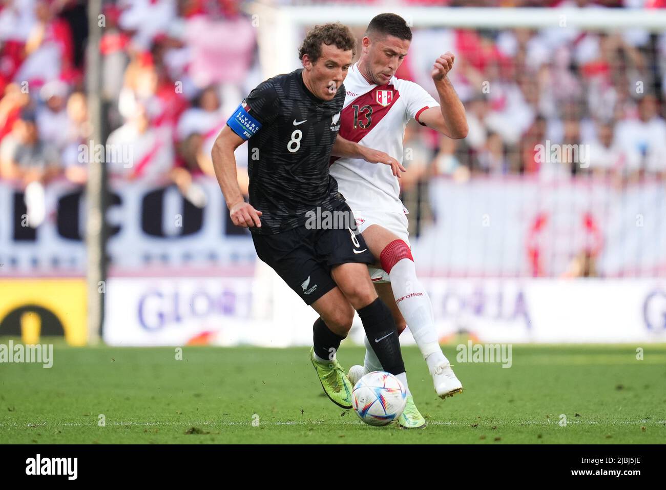 Joe Bell of New Zealand and Renato Tapia of Peru during the friendly match between Peru and New Zealand played at RCDE Stadium on June 5, 2022 in Barcelona, Spain. (Photo by Bagu Blanco / PRESSINPHOTO) Stock Photo
