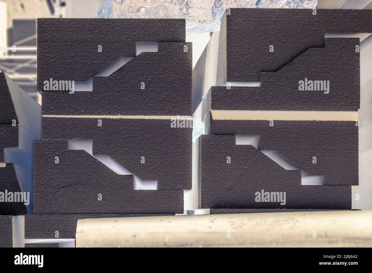 black blocks of a complex profile lie in stacks, selective focus Stock Photo