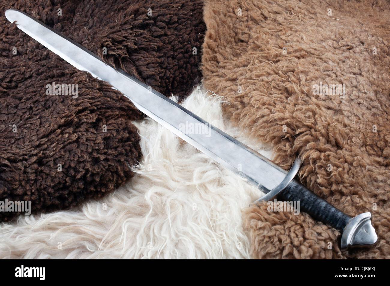 Viking Age sword on sheep fur background Stock Photo