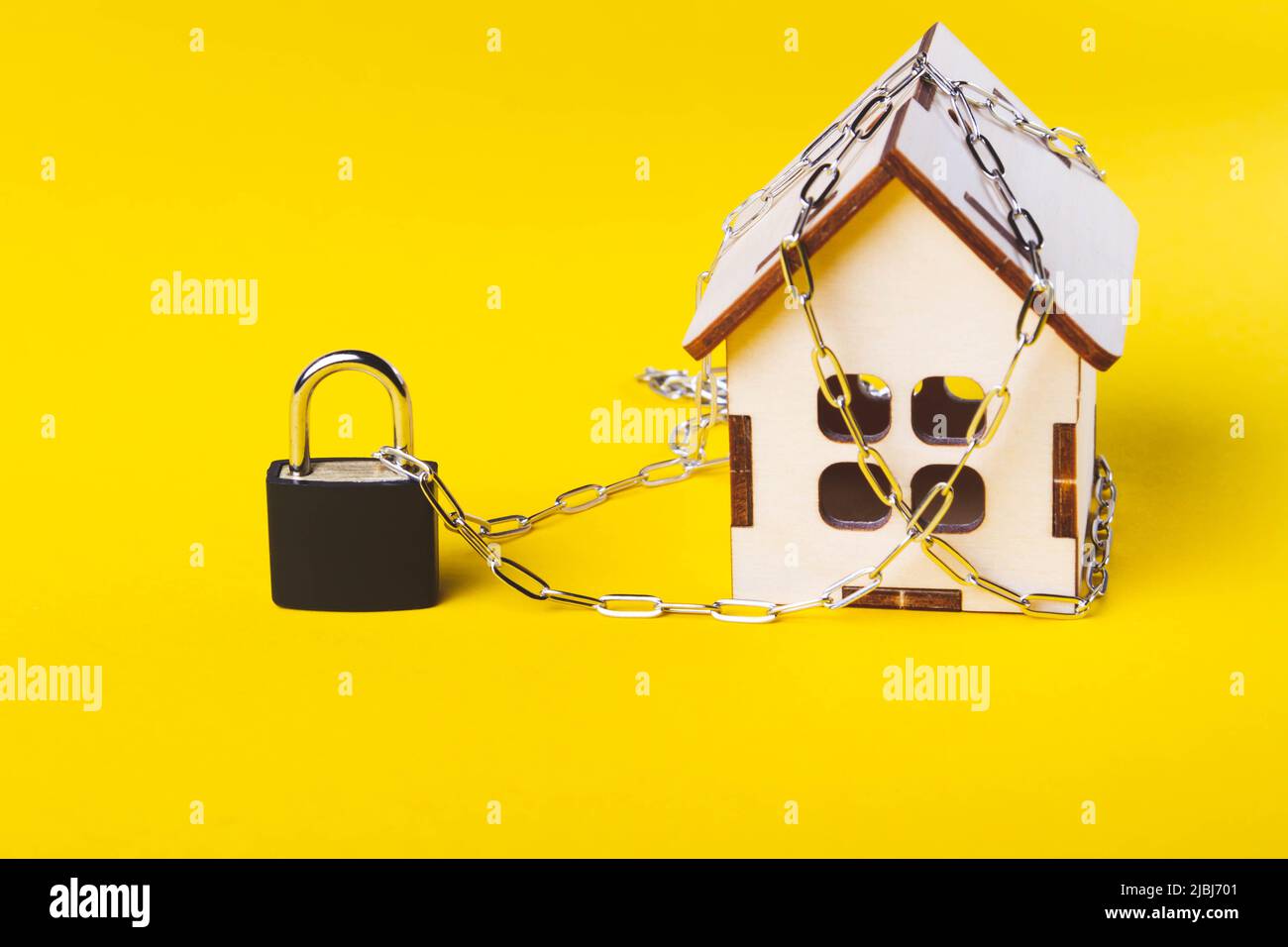 Housing arrest. Castle house. Small toy house and a chain with a lock