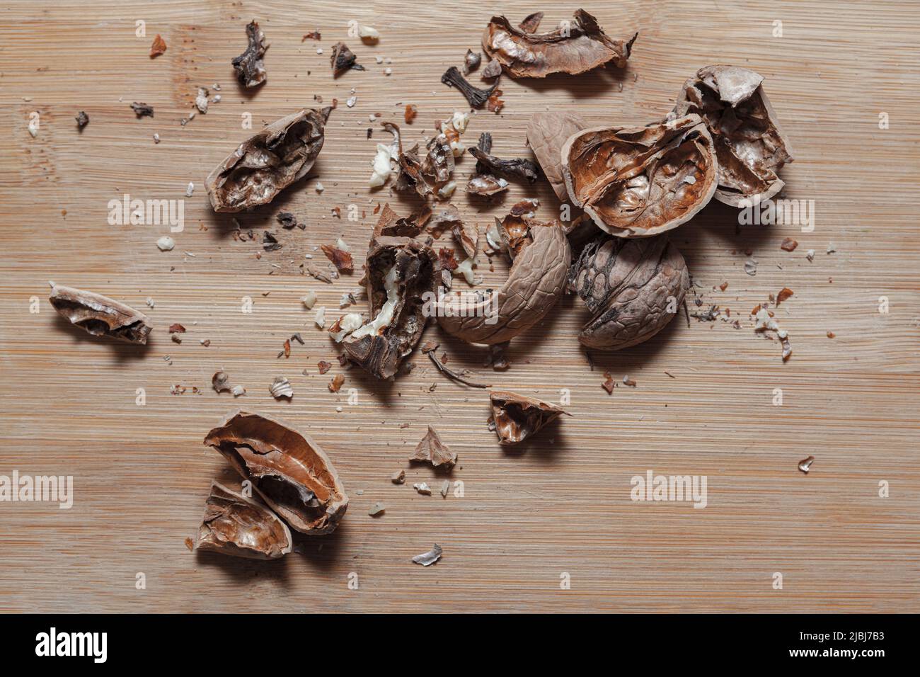 Shelled walnut . Peeled nut shell , wooden background Stock Photo