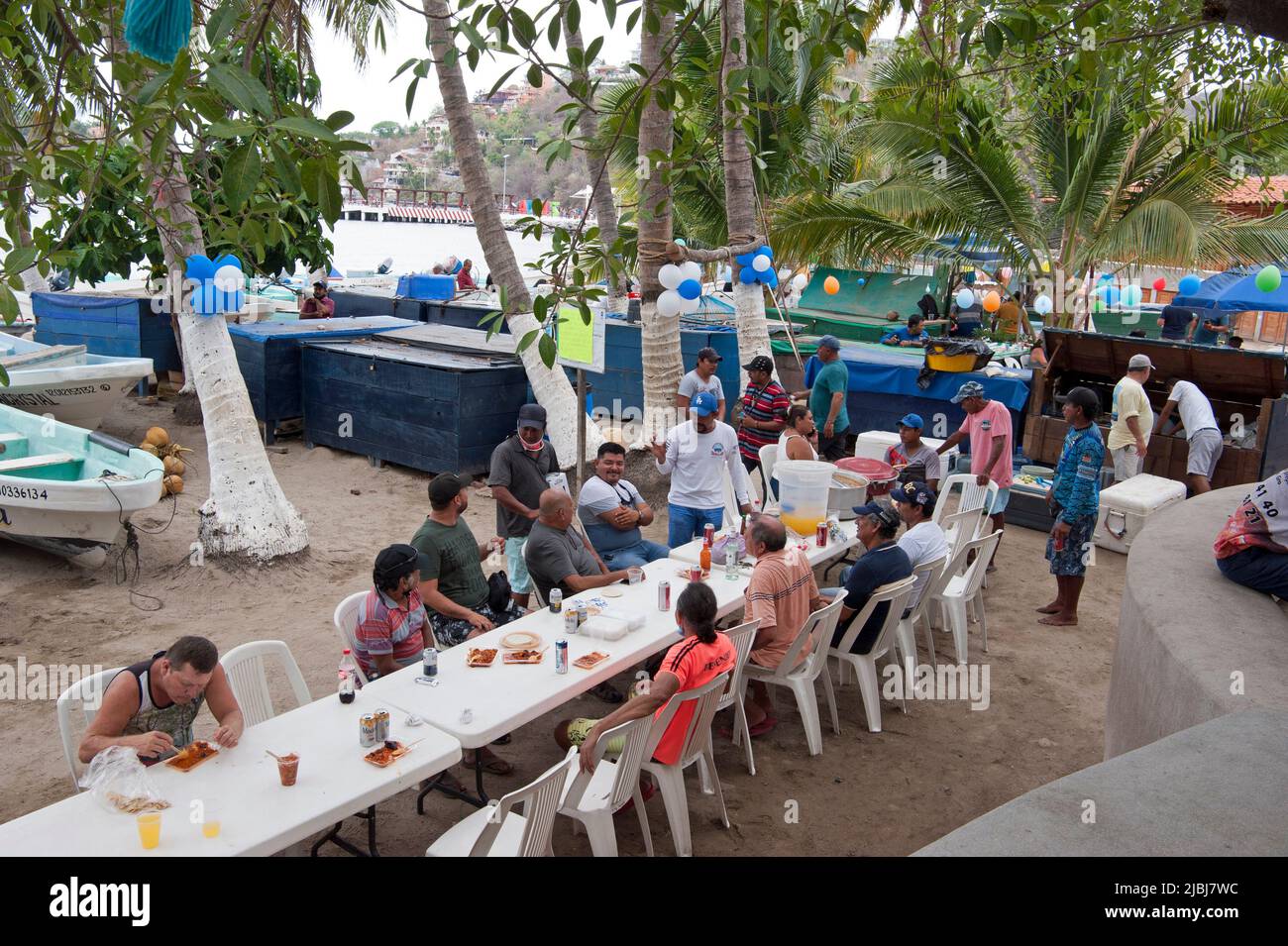 Fisherman enjoying a meal after fishing in Zihuatanejo, Mexico Stock Photo