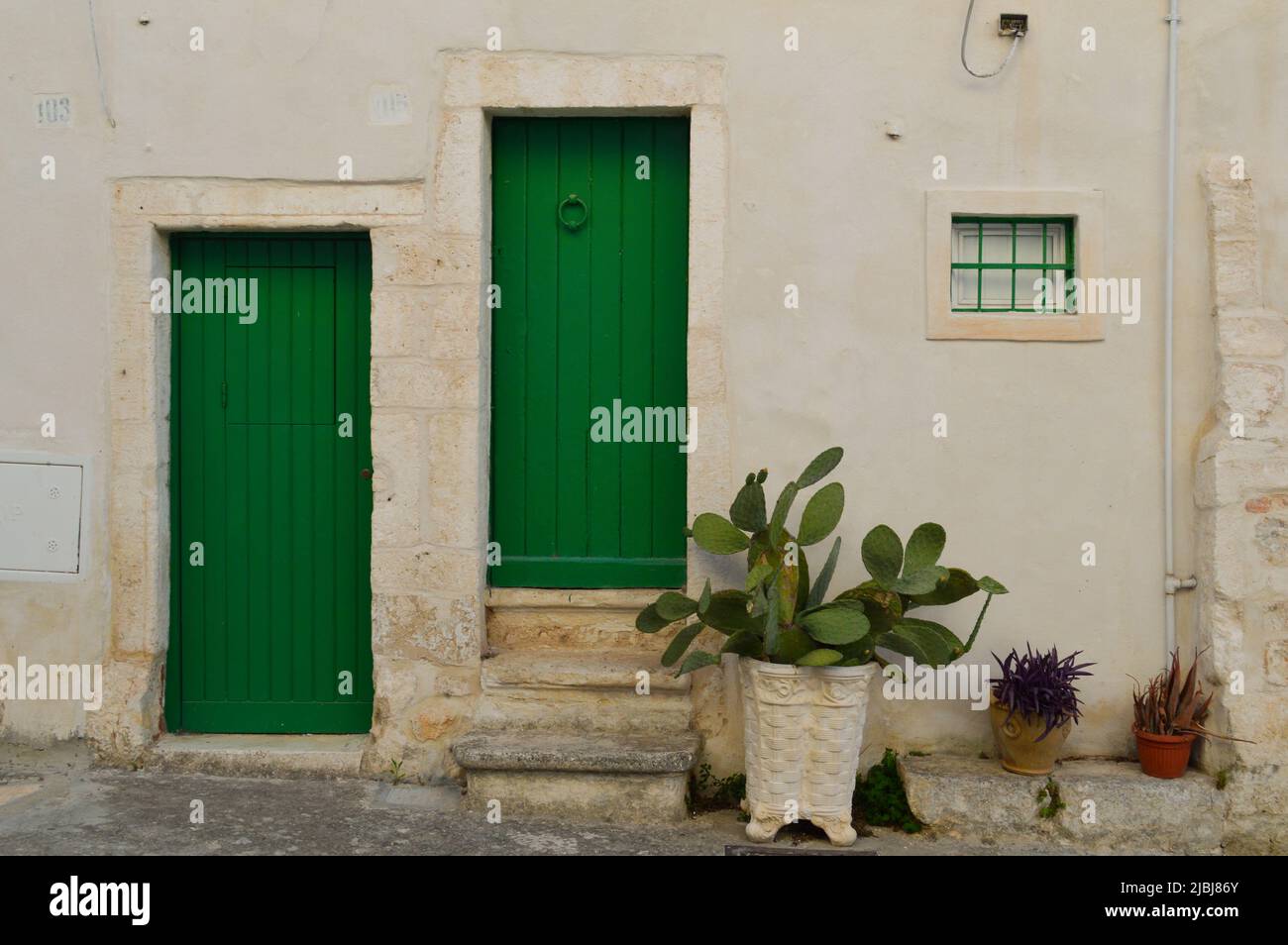 house with green doors and white wall in Ostuni Stock Photo